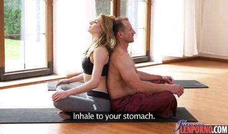 Yoga teacher lowered from the clients tights and teamed member between the elastic buttocks