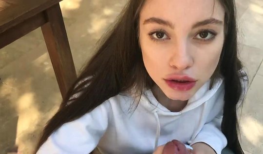 Brunette with long hair stands on knees and makes a home ...