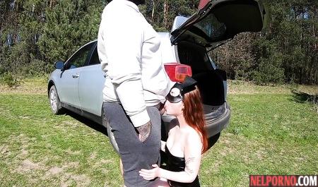 Redhead bitch in a mask outdoors sucks dick a fat husband and Fucks him by the car