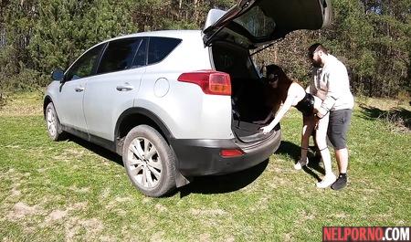 Redhead bitch in a mask outdoors sucks dick a fat husband and Fucks him by the car