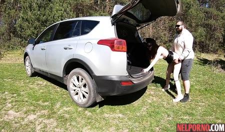 Redhead bitch in a mask outdoors sucks dick a fat husband and Fucks him by the car