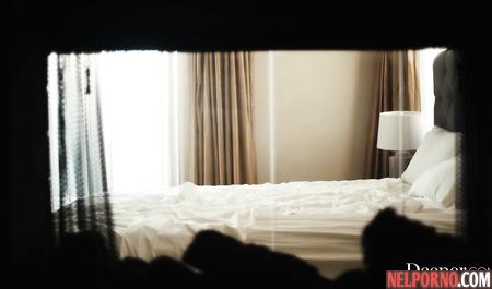 Two young girls and one man in the bedroom engaged in group sex