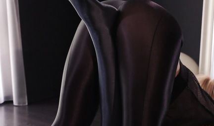 Two lesbians in latex tights fuck each other with a strap-on