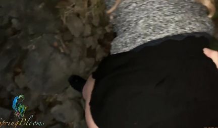 A girl in nature lifts up her black skirt and flashes her tight ass in red panties