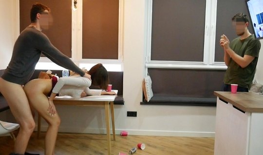 The boy takes pictures on a home camera, as a friend in a...