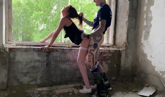 A Russian couple in an abandoned building stood in a pose...