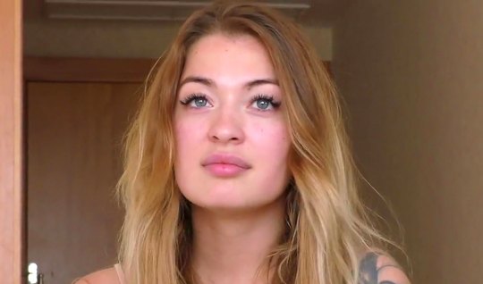 Slim girl at the casting undresses and shows tattoos on a...