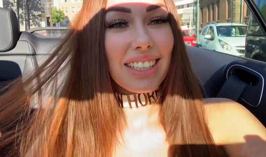 A beautiful girl in nature, then in the car plays with a ...