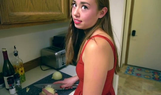 A girl in a red dress in the kitchen is ready for hard ho...