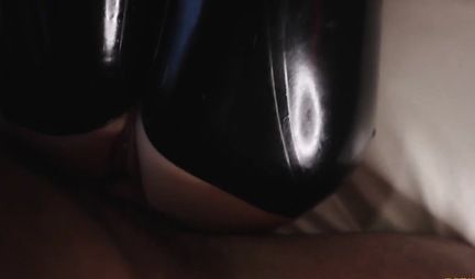 During home anal, a girl in latex fucks herself with a sex toy