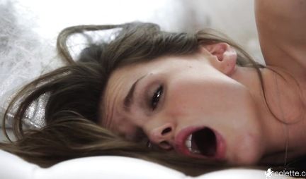 Brunette spreads her legs for masturbation with sex toys on a soft sofa