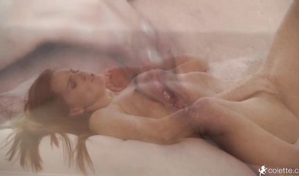 Brunette spreads her legs for masturbation with sex toys on a soft sofa