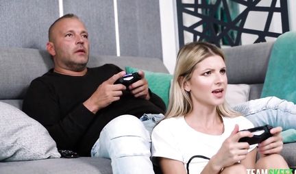 Skinny blonde gets a hard cock in her pussy while playing the console