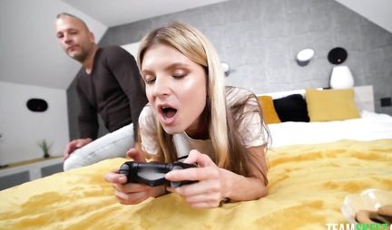 Skinny blonde gets a hard cock in her pussy while playing the console
