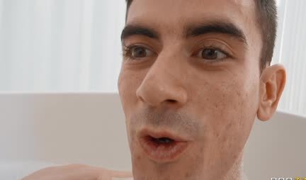 Busty MILF gives a footjob to a young male cock in the bathroom