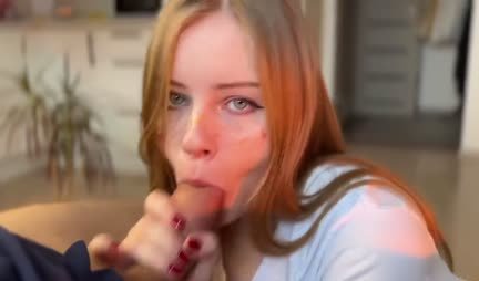 A young girl gives a blowjob to a friend with a fat cock