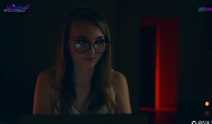 A passionate lesbian sucks a strap-on and rides it with a wet pussy