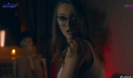 A passionate lesbian sucks a strap-on and rides it with a wet pussy