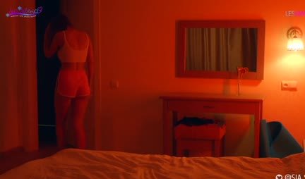 A passionate lesbian sucks a strap-on and rides it with a wet pussy