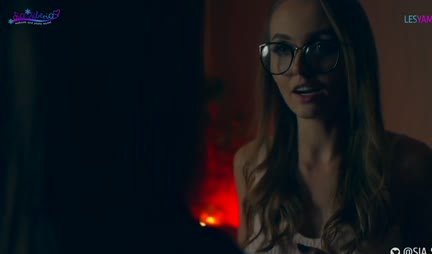 A passionate lesbian sucks a strap-on and rides it with a wet pussy