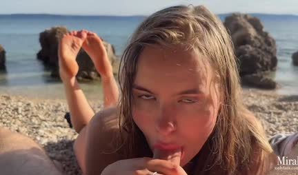 Russian wet chick gives a blowjob to a guy on a wild beach