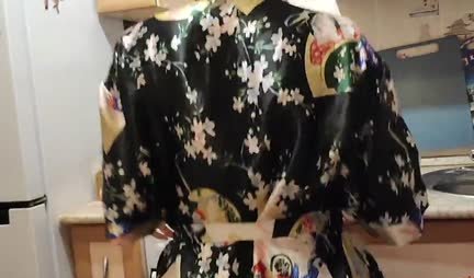 A young housewife in a robe gets up doggy style for fun