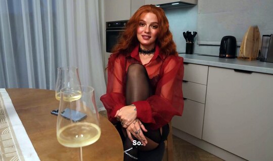 The redhead drank some wine and was ready for debauchery